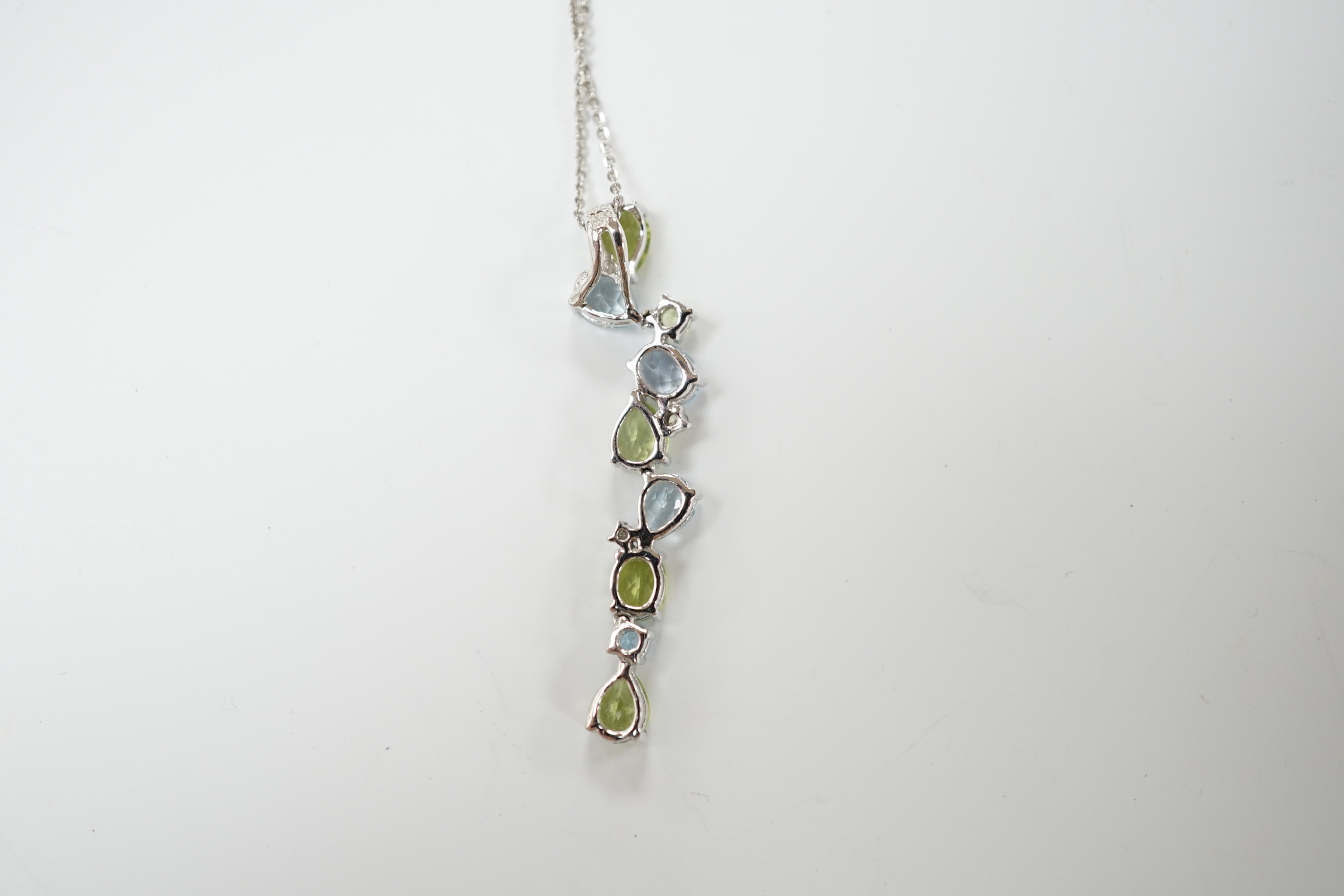 A modern 9ct white gold, peridot and blue topaz set pendant, 37mm, on a 375 chain, 40cm, gross weight 3.4 grams.